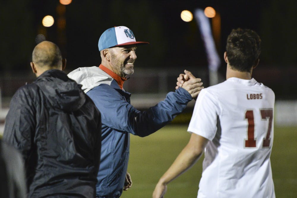Head Lobo soccer coach Jeremy Fishbein congratulates one of his players after scoring a goal against LMU Oct. 4, 2017 at the UNM Soccer Complex. Four new players have signed National Letters of Intent and will be apart of the University of New Mexico in the fall.