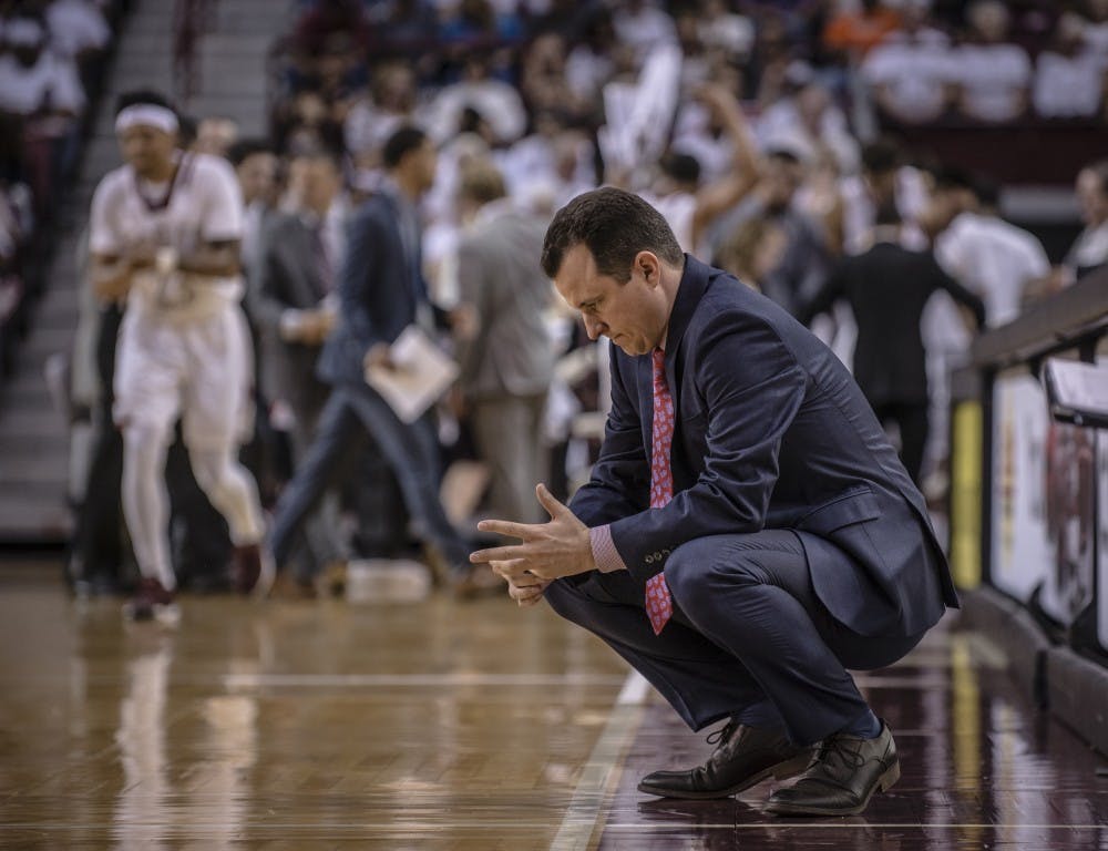 UNM&nbsp;Men's basketball coach Paul Weir sits on the sidelines on Nov. 17, 2017 in the Aggies hometown of Las Cruces.