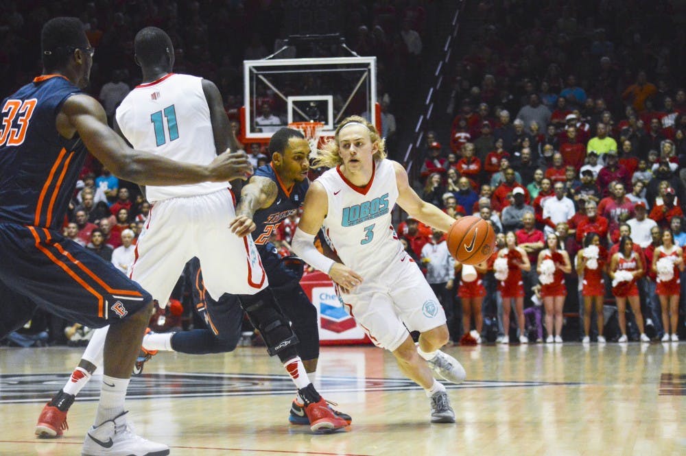 Lobo senior guard Hugh Greenwood, 3, attempts to run past Titan redshirt junior guard Alex Harris, 23, during the game against Cal State Fullerton at the Pit on Sunday night. The Lobos are playing three games at a tournament in San Juan, Puerto Rico from Thursday to Sunday.