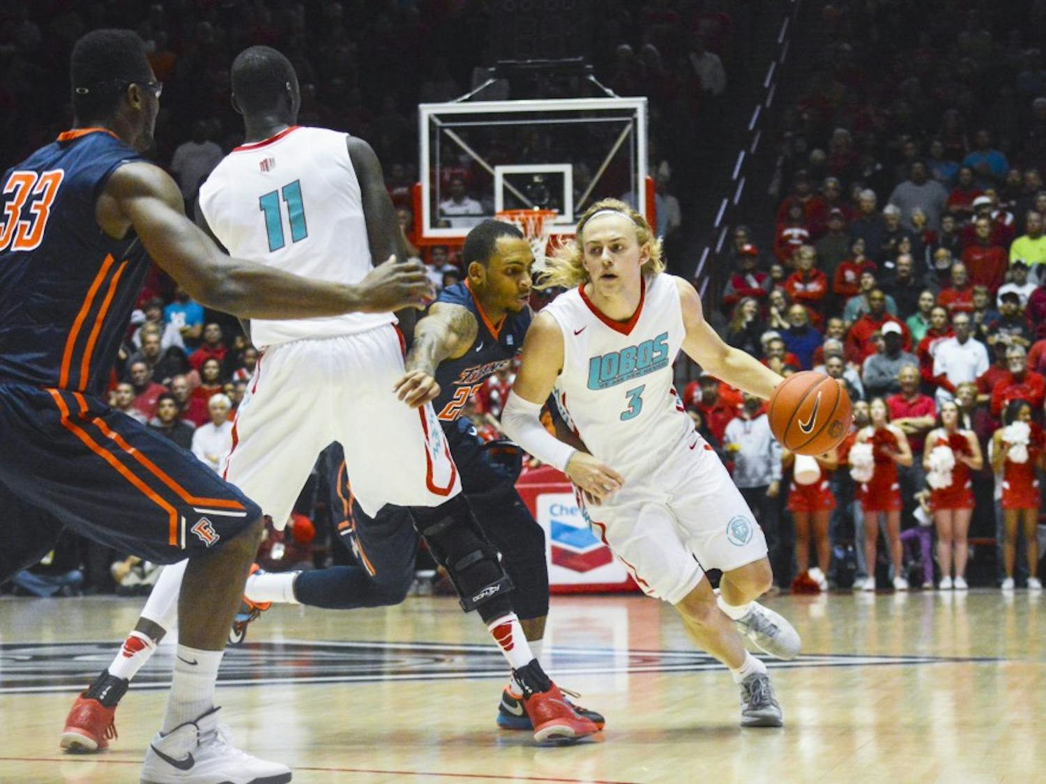 Lobo senior guard Hugh Greenwood, 3, attempts to run past Titan redshirt junior guard Alex Harris, 23, during the game against Cal State Fullerton at the Pit on Sunday night. The Lobos are playing three games at a tournament in San Juan, Puerto Rico from Thursday to Sunday.