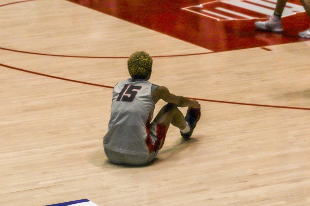Aisia Robertson sits down after missing the final shot of the game. Lady Lobos lost 79-76 to Auburn in the quarterfinals of the preseason Women's National Invitational Tournament.