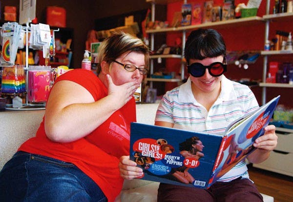 Self Serve: Your Sexuality Resource Center owners Molly Adler, left, and Matie Fricker look at a 3-D pinup girl book at their store at 3904B Central Ave. S.E. on July 19. 