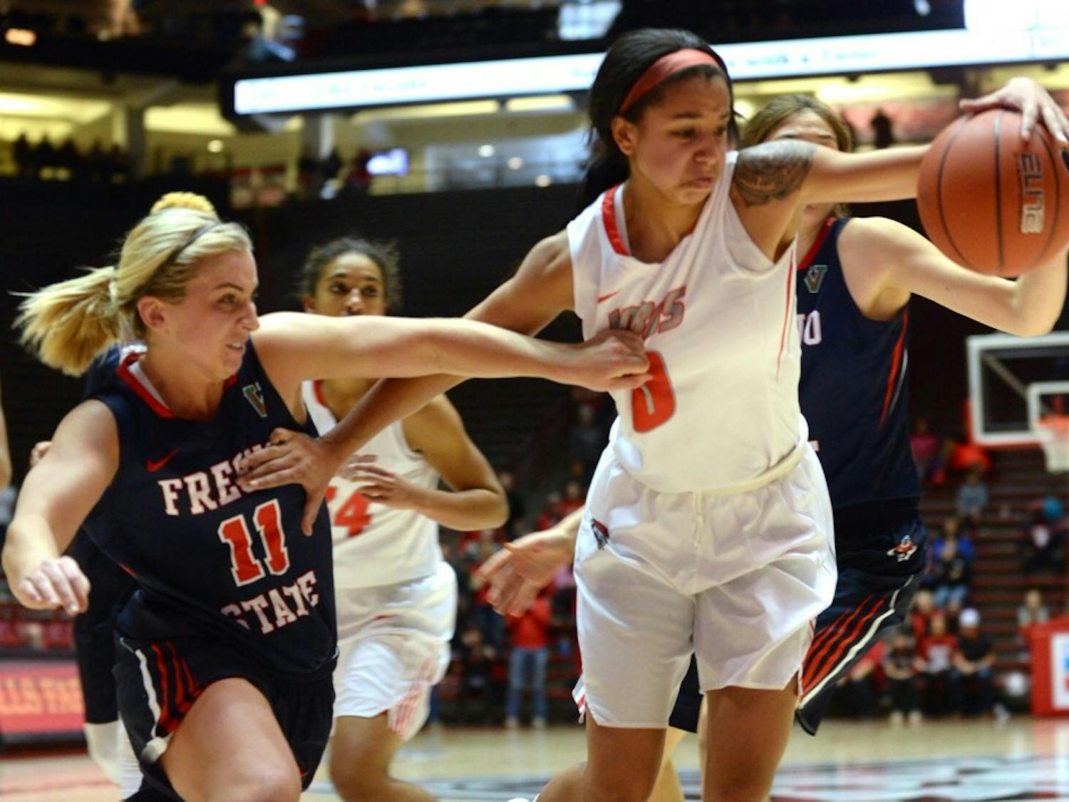 Sophomore guard Cherise Beynon fights for the ball against a Fresno State player at WisePies Arena Saturday night. The Lobos play Utah State Saturday in Logan, Utah.
