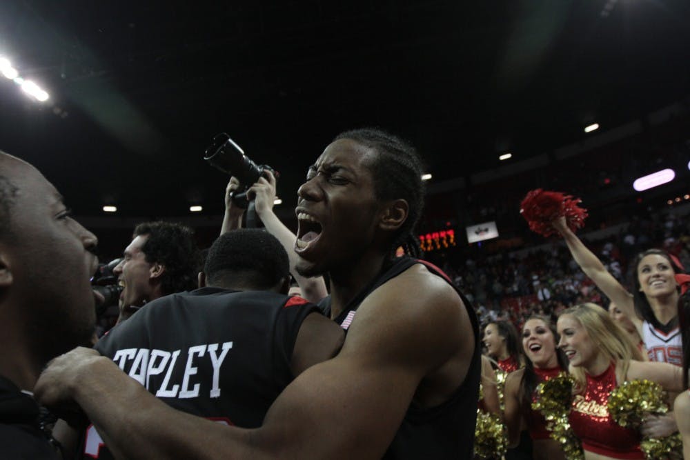 	Aztecs’ point guard, D.J. Gay, center, and Brian Carlwell, left, huddle at the conclusion of Saturday’s MWC tournament final. The
Aztecs earned an automatic bid to the NCAA Tournament by defeating UNLV.