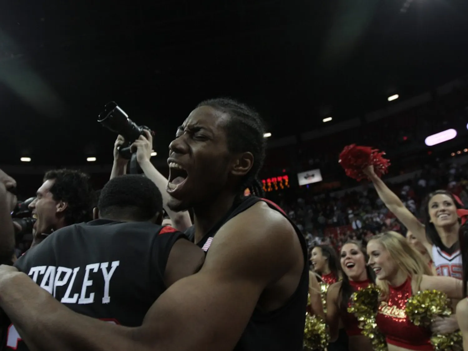 Aztecs’ point guard, D.J. Gay, center, and Brian Carlwell, left, huddle at the conclusion of Saturday’s MWC tournament final. The
Aztecs earned an automatic bid to the NCAA Tournament by defeating UNLV.