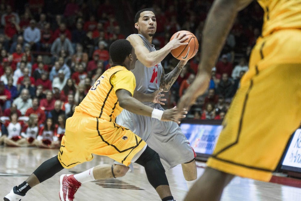	Lobo guard Kendall Williams attempts to avoid several Wyoming defenders at the Pit on Wednesday night. The Lobos defeated the Cowboys 66-61 in overtime. 