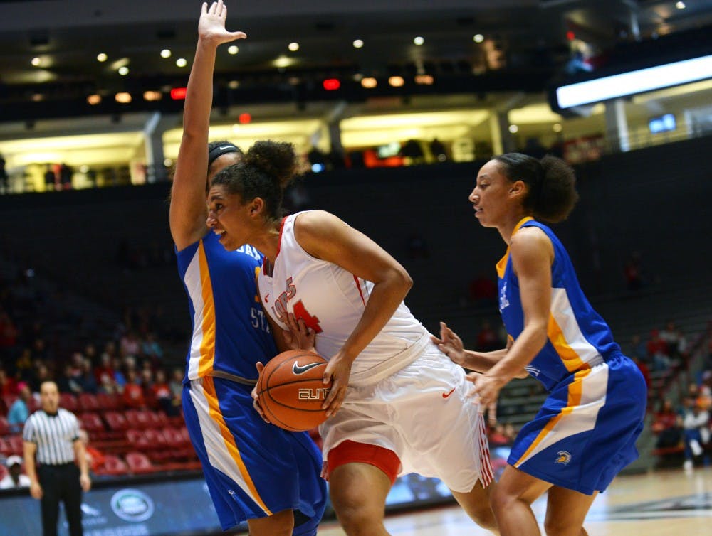 Redshirt junior center Whitney Johnson charges past two San Jose State players Saturday, Jan. 23, 2016, at WisePies Arena. The Lobo beat Air Force 63-33.