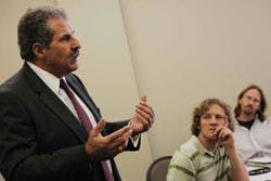 Sul Kassicieh, associate dean for research and economic development, talks about the Anderson Schools of Management's Technology Business Plan Competition while student Nick Hoffman listens Tuesday in the SUB. 