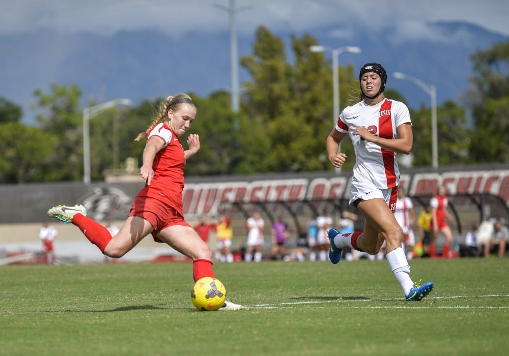 Forward Quincy Slora passes the ball down field while evaiding a UNLV player during their game Sunday Oct. 4, 2015. The Lobos lost 1-3 and will play San Jose Oct. 16. 