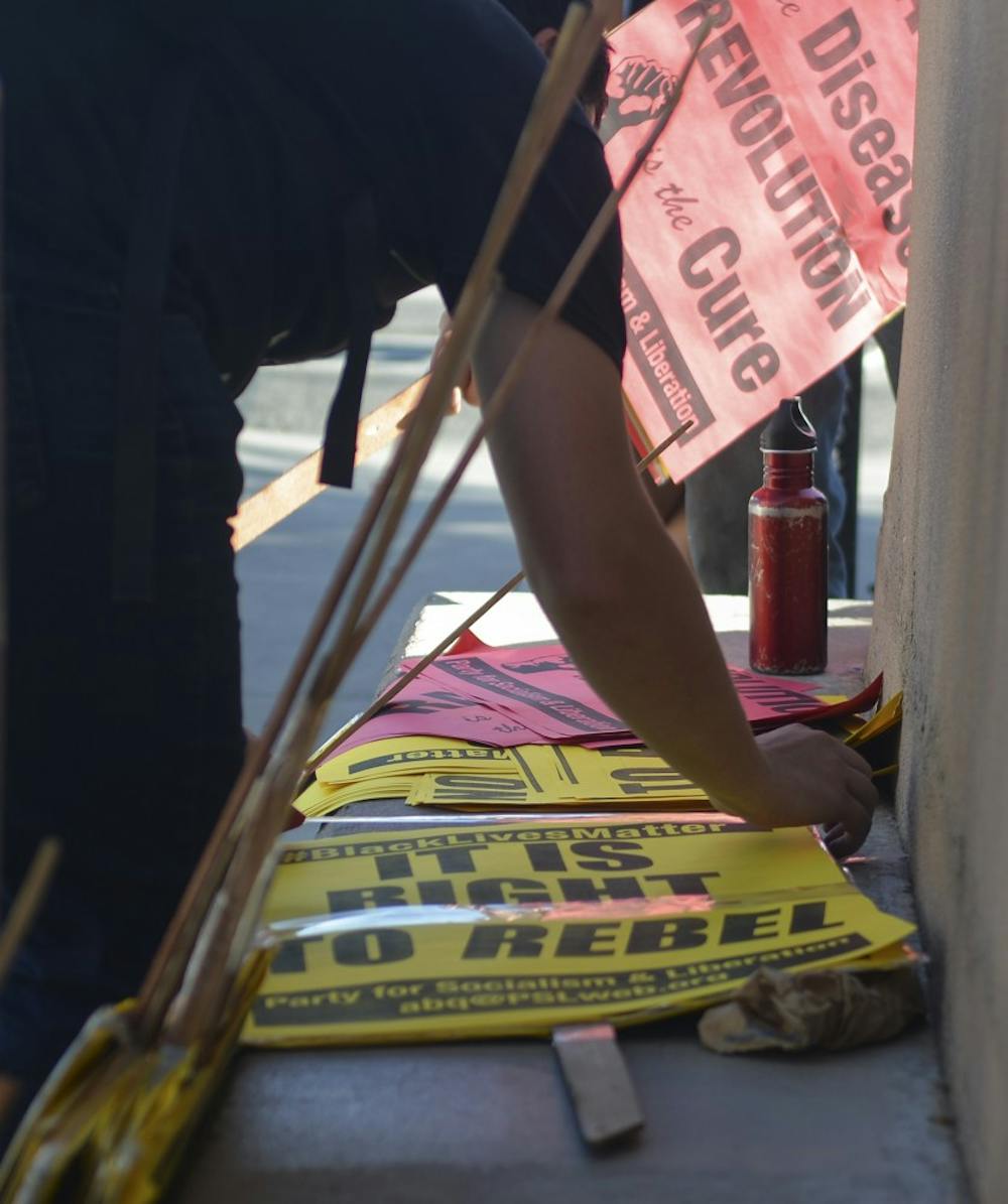 A protester put together the protest signs on Wednesday afternoon as part of the Black Lives Matter movement. Party of the Socialism and Liberation organized the rally.
