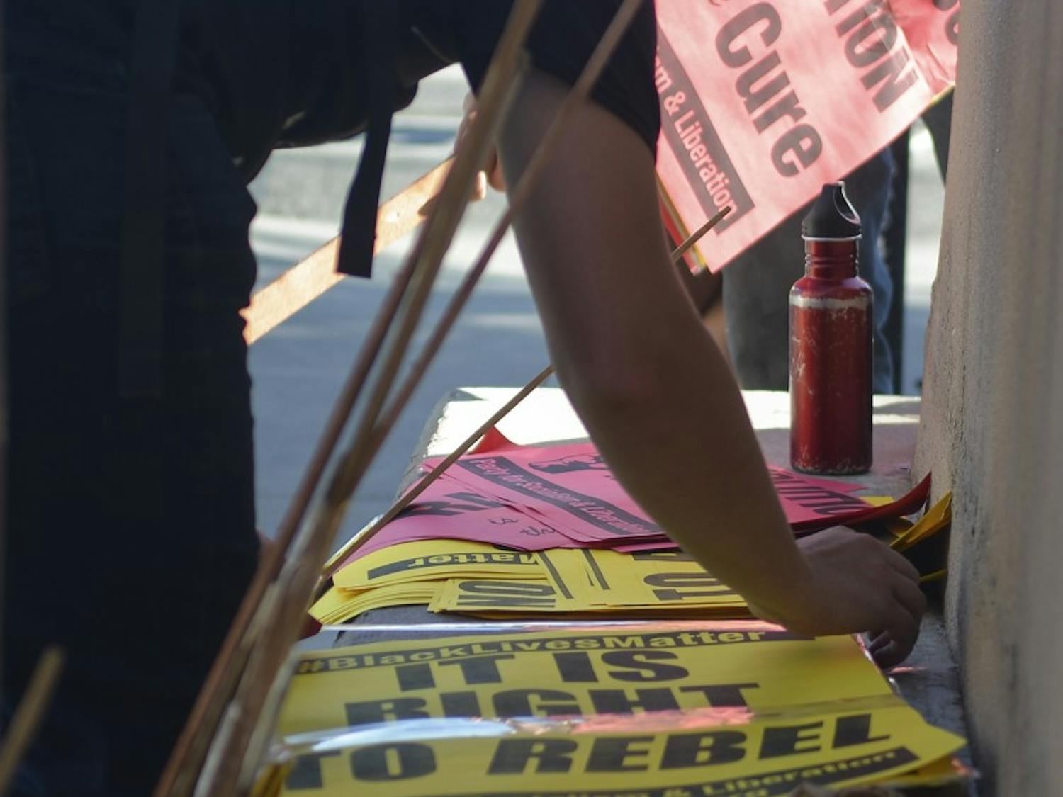 A protester put together the protest signs on Wednesday afternoon as part of the Black Lives Matter movement. Party of the Socialism and Liberation organized the rally.