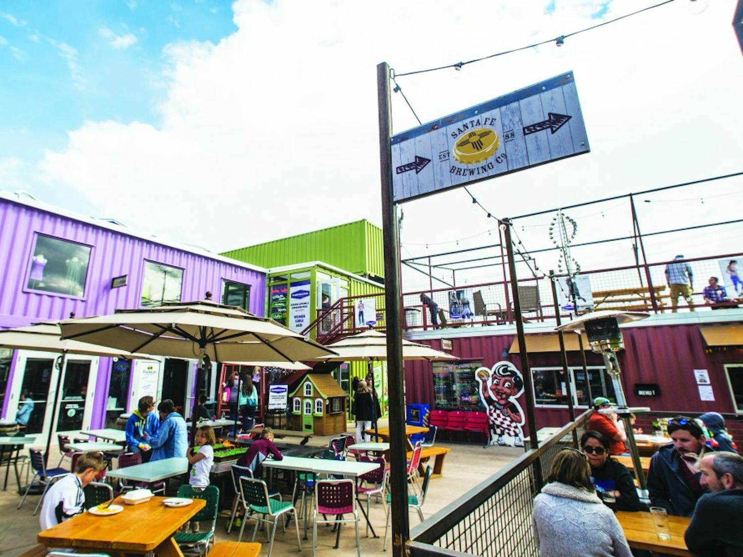 People sit outside on patios Sunday afternoon at Green Jeans Farmery. Green Jeans is a project that opened in early 2015 which consists of a complex of shipping containers that house a brewery and various restaurants.