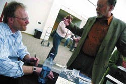 Sam Tanenhaus, editor of the New York Times Book Review, left, signs a copy of his book, Whittaker Chambers: A Biography, for Jim Mafchir on Wednesday in the SUB. 