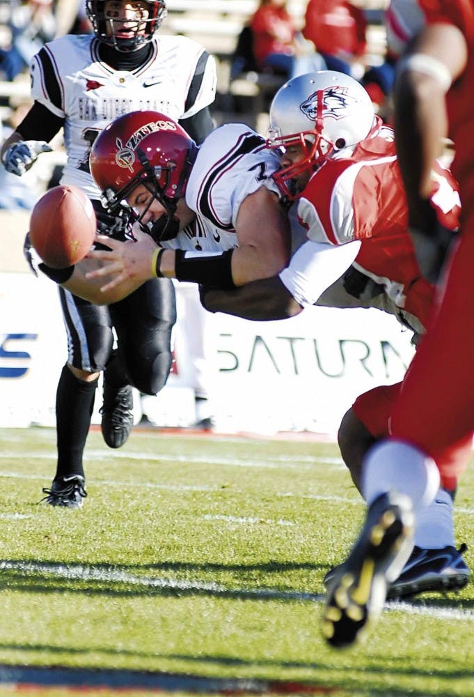 UNM safety O.J. Swift, right, forces San Diego State quarterback Kevin O'Connell to fumble the ball at the goal line during the third quarter of Saturday's 41-14 win at University Stadium. The Lobos recovered the ball. 