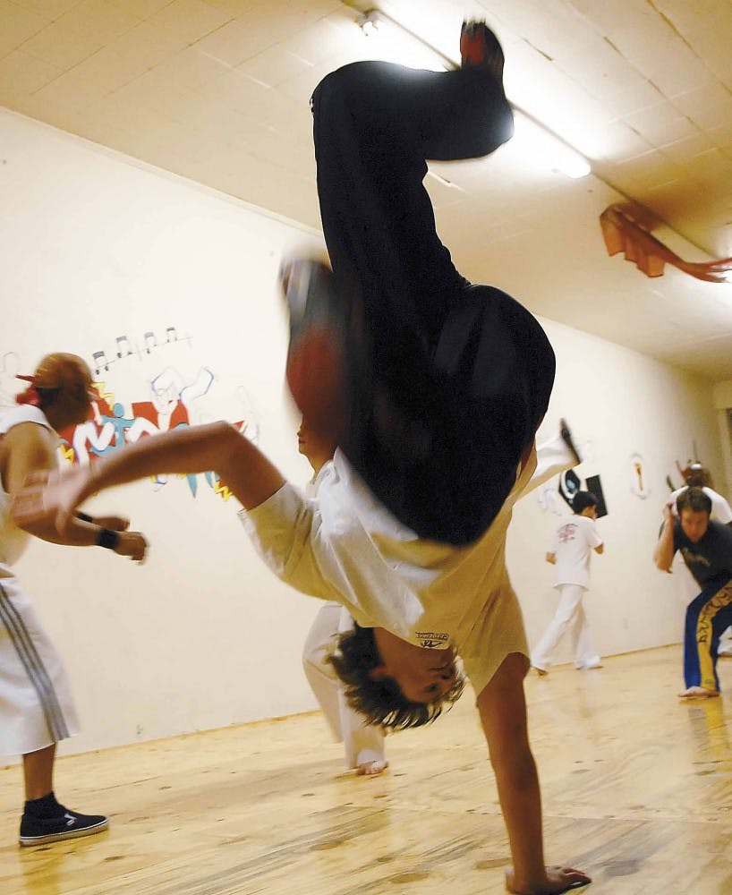 UNM Capoeira Club president Daniel Young warms up before class Wednesday at Capoeira Pegadas on 4817 Central Avenue N.E.