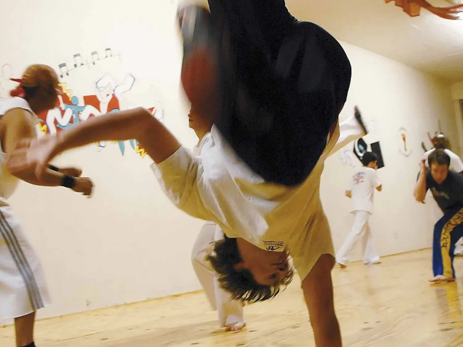 UNM Capoeira Club president Daniel Young warms up before class Wednesday at Capoeira Pegadas on 4817 Central Avenue N.E.