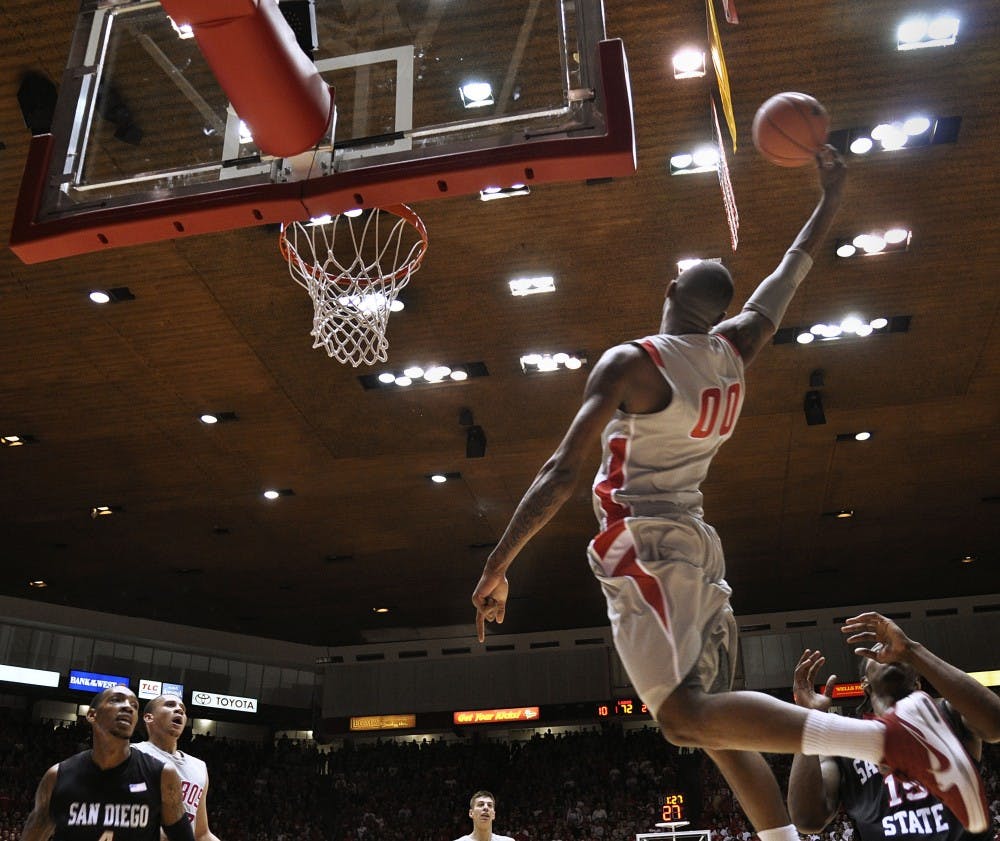 	A.J. Hardeman stretches out while reaching for an alley-oop pass against San Diego State on Saturday at the Pit. The Lobos outlasted the Aztecs 88-86 in overtime, putting them in a three-way tie for first in the Mountain West Conference. 