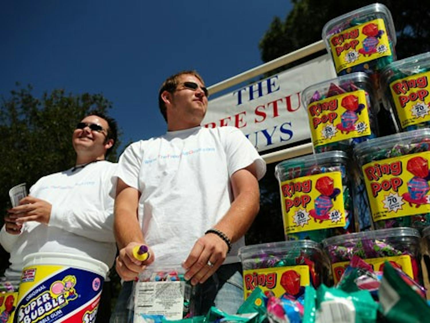 The Free Stuff Guys - Trevor Jordan, left, and David Knuckles - hand out Ring Pops in Smith Plaza on Thursday.