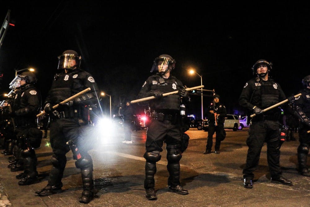 Albuquerque riot police officers stand&nbsp;ready on the corner of&nbsp;Yale Boulevard&nbsp;and Central Avenue on&nbsp;Wednesday night in an attempt to disperse anti-Donald Trump protesters.&nbsp;