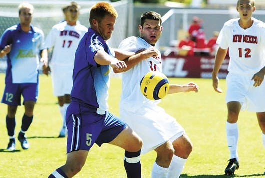 Tulsa's Joseph Wear, left, battles for possesion of the ball with P.J. Wilson during the Lobos' 1-0 victory Sunday at University Stadium.