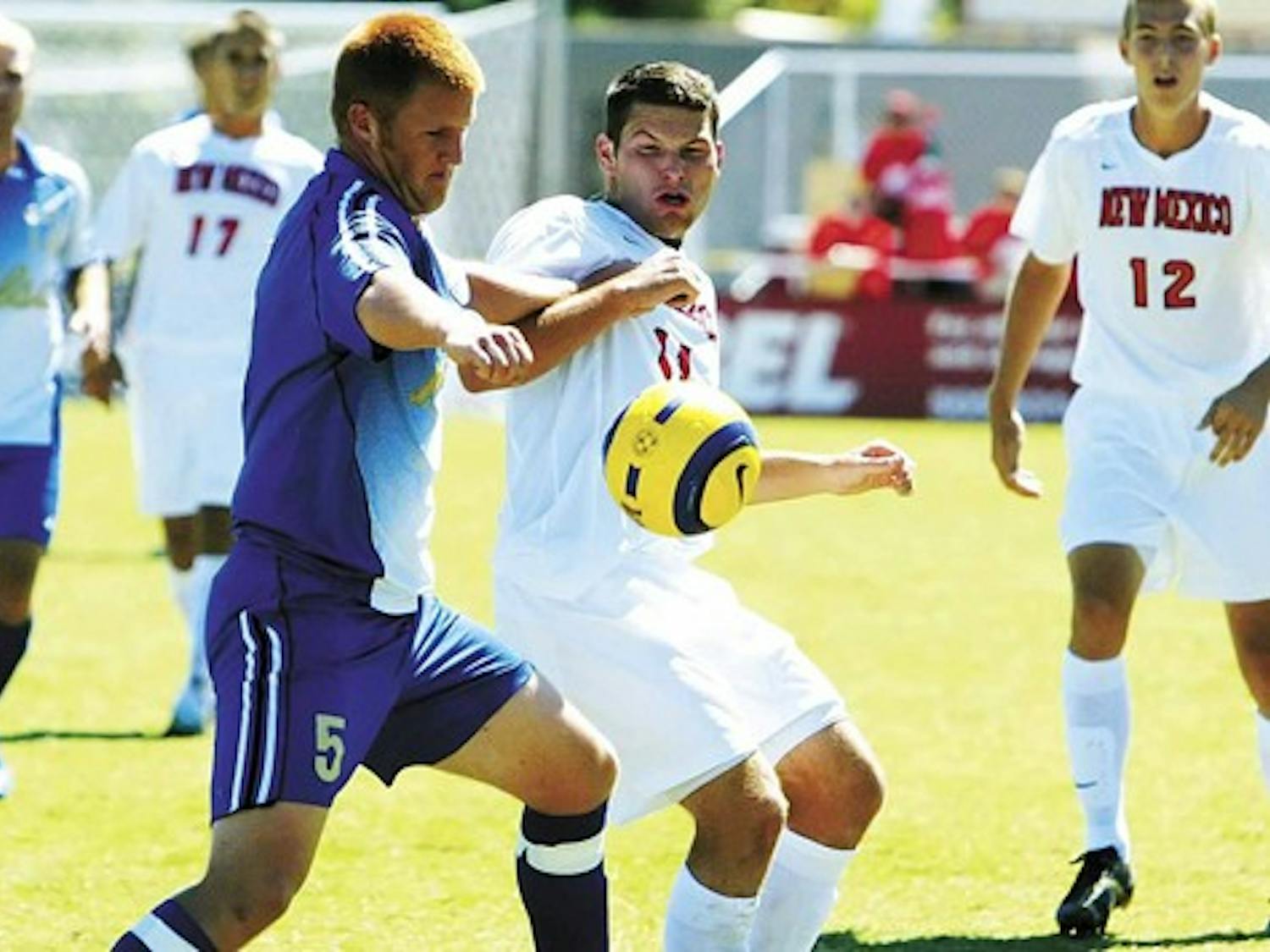 Tulsa's Joseph Wear, left, battles for possesion of the ball with P.J. Wilson during the Lobos' 1-0 victory Sunday at University Stadium.