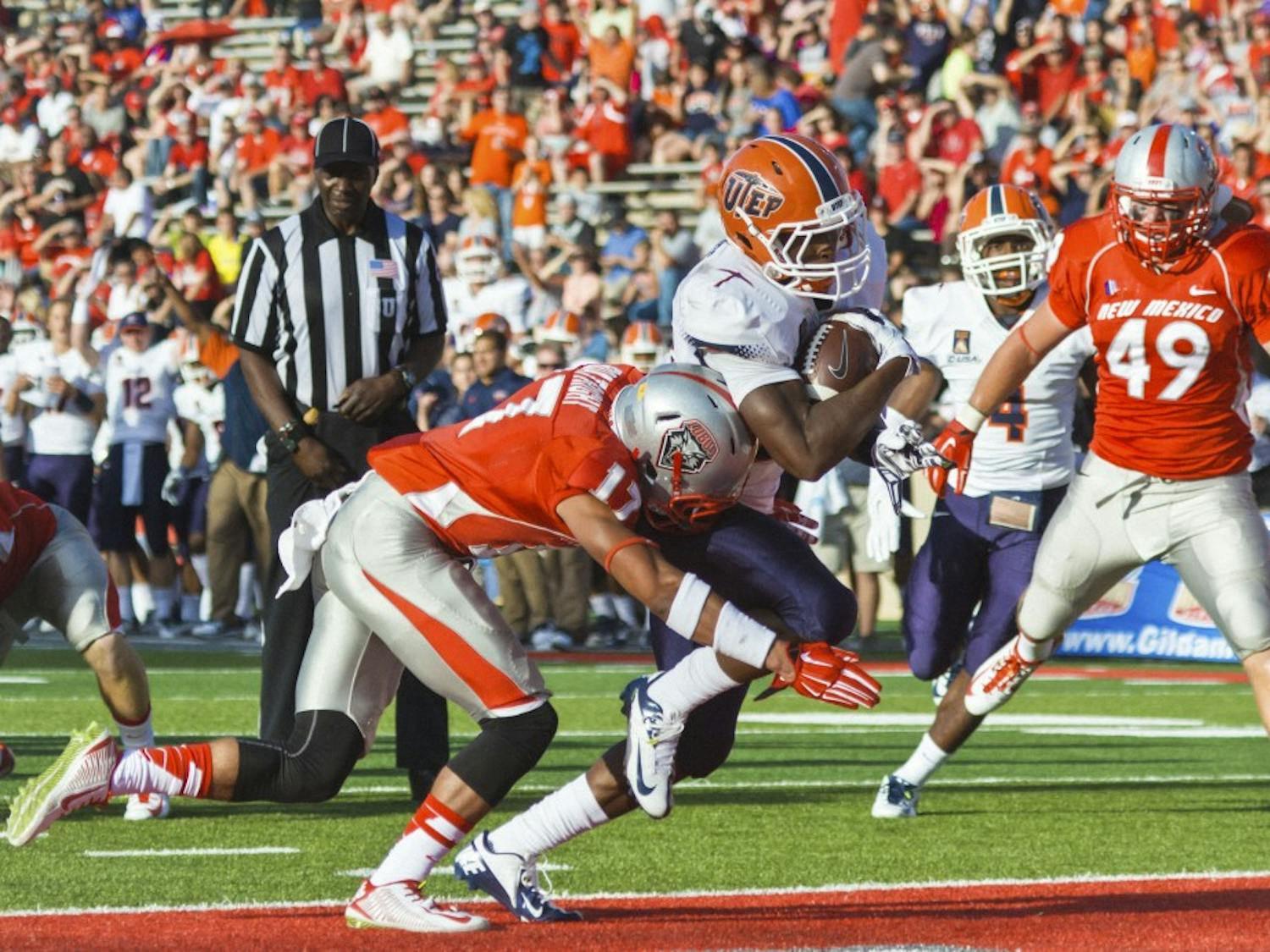 UTEP's Aaron Jones #29 runs in the first touchdown as he gets past the New Mexico defense. The Lobos faced the UTEP Miners for the first game of the season Saturday evening at University Stadium. UTEP defeated New Mexico 31-24.