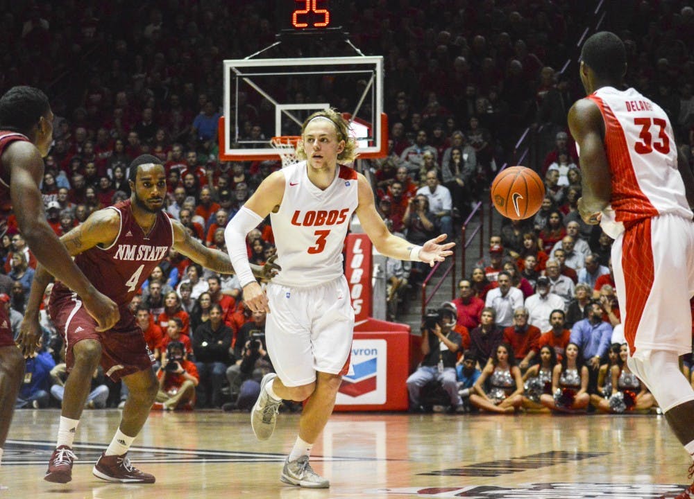 Lobo senior guard Hugh Greenwood, 3, tosses the ball to senior guard Deshawn Delaney, 33, during the game against New Mexico State University at WisePies Arena on Wednesday night. The Lobos defeated Valparaiso Saturday in Valparaiso, Indiana 63-46.