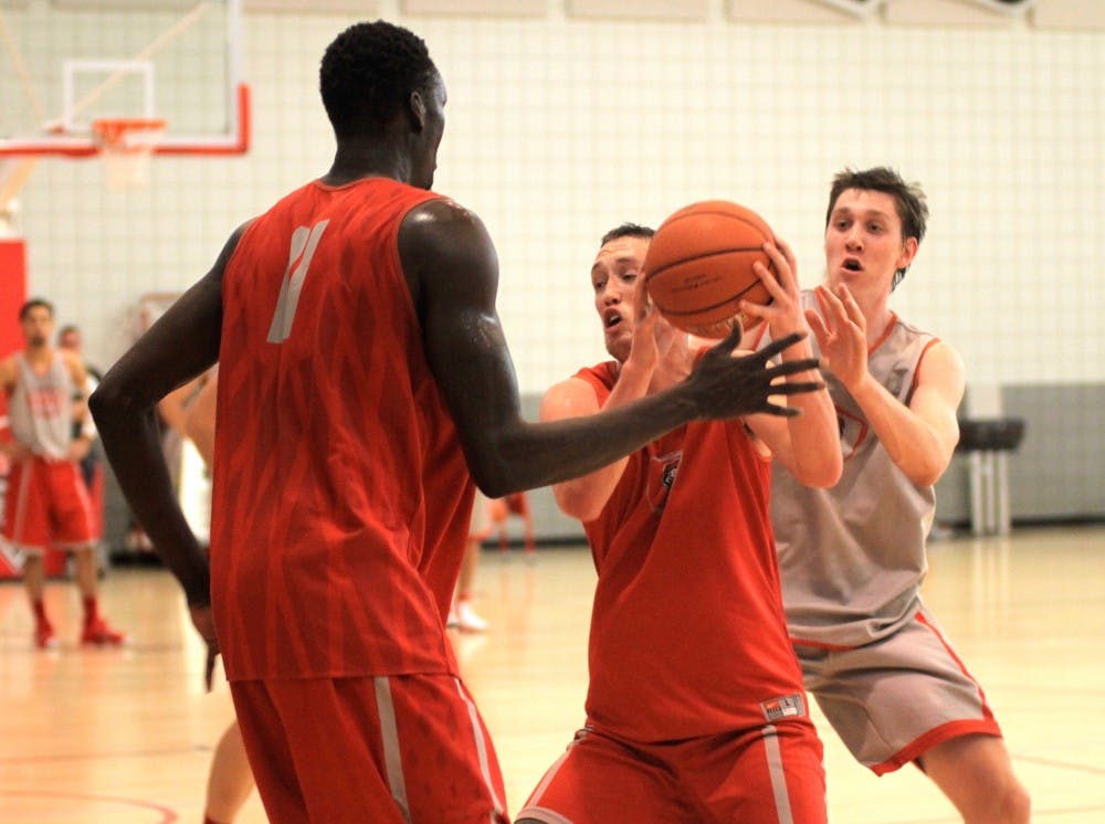 New Mexico's Cullen Neal, center, collects the ball under pressure from Obij Aget, left, under pressure from Joe Fursdinger during practice Tuesday afternoon at the Rudy Davalos Basketball Center. The Lobos released the schedule for the upcoming season on Tuesday, one that features games against seven NCAA tournament participants.