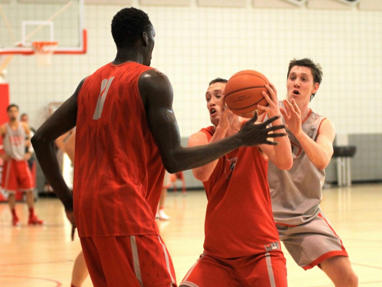 New Mexico's Cullen Neal, center, collects the ball under pressure from Obij Aget, left, under pressure from Joe Fursdinger during practice Tuesday afternoon at the Rudy Davalos Basketball Center. The Lobos released the schedule for the upcoming season on Tuesday, one that features games against seven NCAA tournament participants.