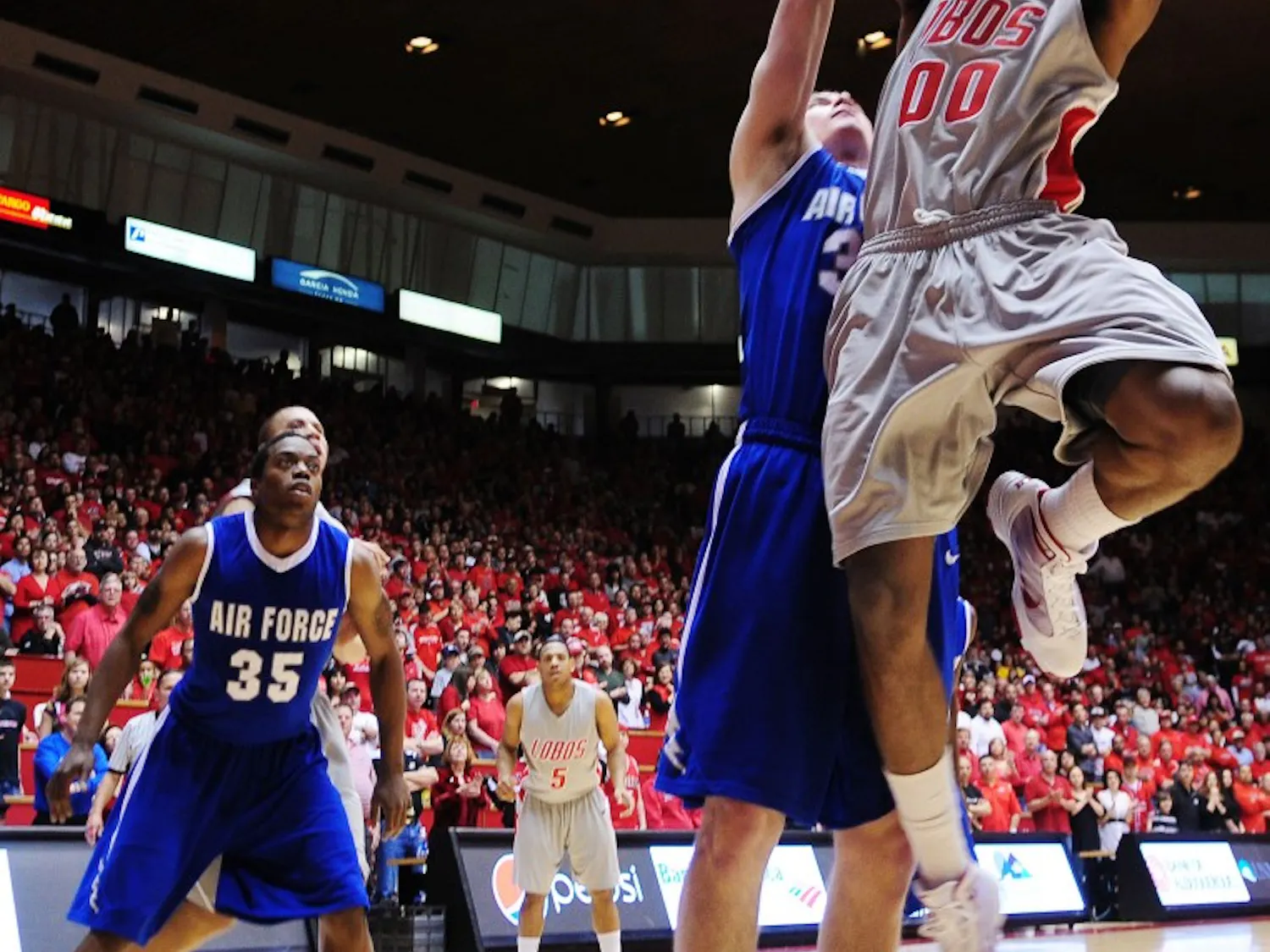 Forward A.J. Hardeman shoots past Air Force’s Mike McLain. The Lobos look to solidify the Mountain West Conference regular-season title tonight against TCU.