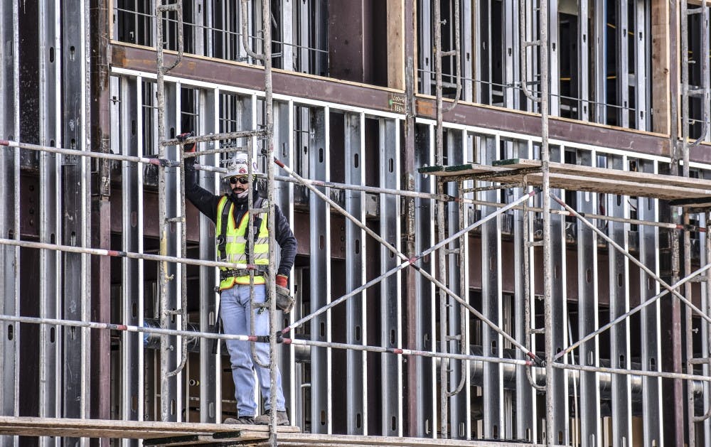 Construction workers at the Physics, Astronomy and Interdisciplinary Science construction site.