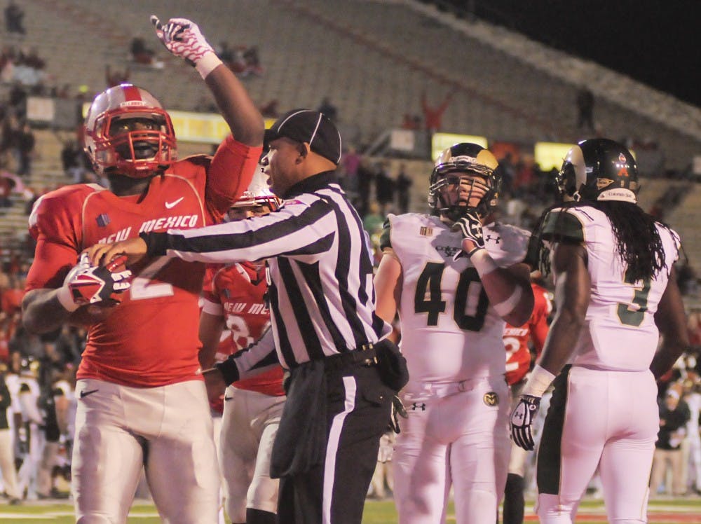 	UNM senior running back Crusoe Gongbay celebrates a touchdown he made during the game against Colorado State at University Stadium on Nov 16, 2013. The rape charges against Gongbay, UNM redshirt senior cornerback SaQwan Edwards and CNM student Ryan Ruff were dropped by the District Attorney’s office.