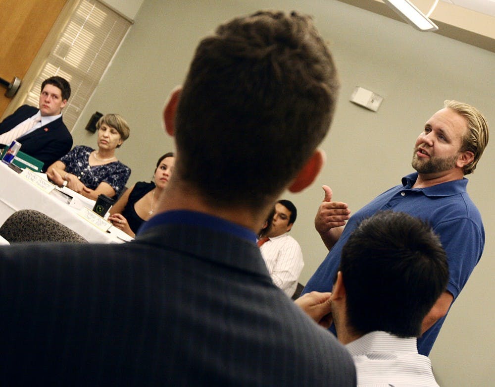 	Student Veterans President Zach Mutchler, right, speaks during the first ASUNM meeting at the SUB on Monday. Mutchler proposed that UNM take Veterans Day off.