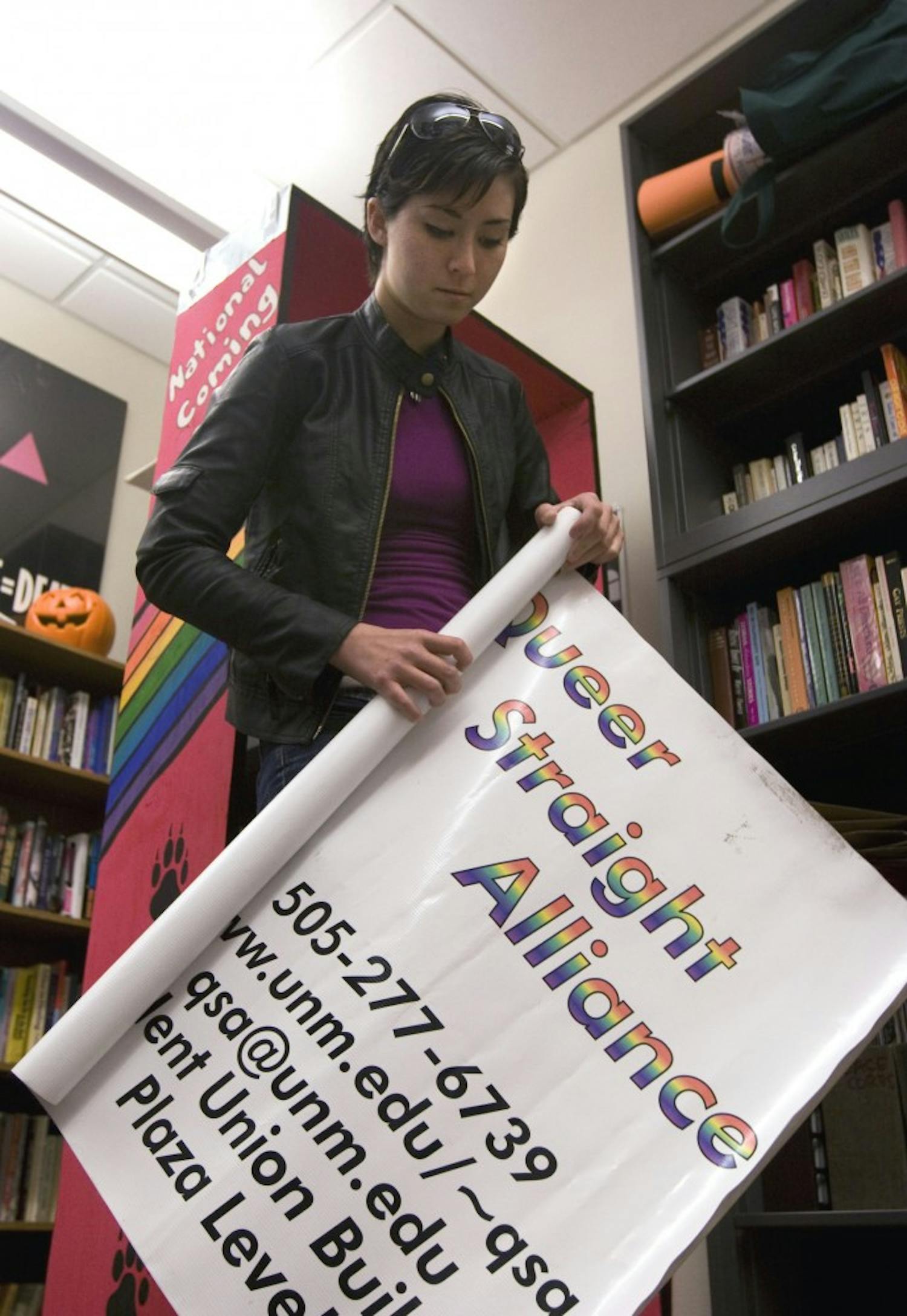 	Queer Straight Alliance president Brandy Rodke rolls up a banner in their SUB office. QSA membership increased to 50 attendees for their meetings from 10 attendees last semester. 
