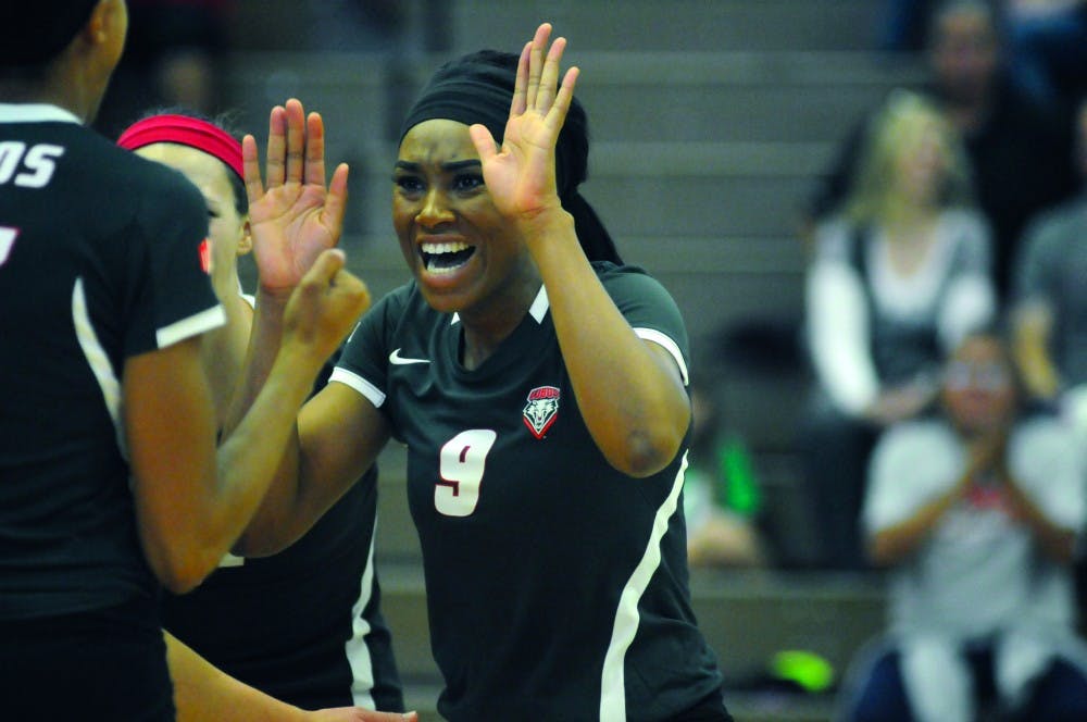 Simone Henderson congratulates her teammates during their game against San Jose State Oct. 25, 2014. Henderson had 21 kills in Saturday’s game against Ball State as the Lobos went 2-1 in three matches at the Ball State Active Ankle Challenge.