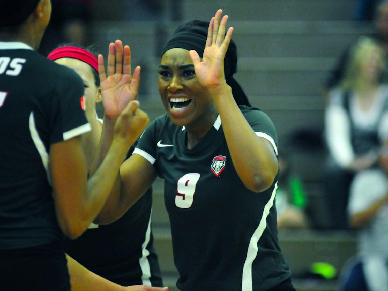Simone Henderson congratulates her teammates during their game against San Jose State Oct. 25, 2014. Henderson had 21 kills in Saturday’s game against Ball State as the Lobos went 2-1 in three matches at the Ball State Active Ankle Challenge.