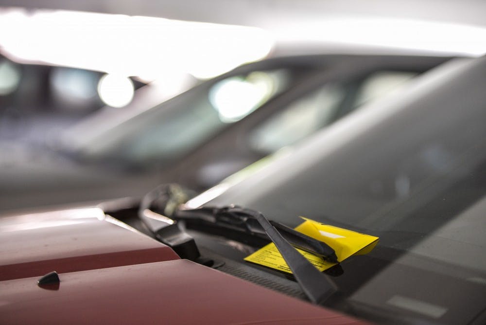 A parking citation sits placed on a vehicle at the yale structure on UNM Main Campus Wednesday Sept. 21, 2016. The UNM Bursar's office and the Parking and Transportation office can threaten to disenroll students that have outstanding parking violations, even if family member are at fault.&nbsp;