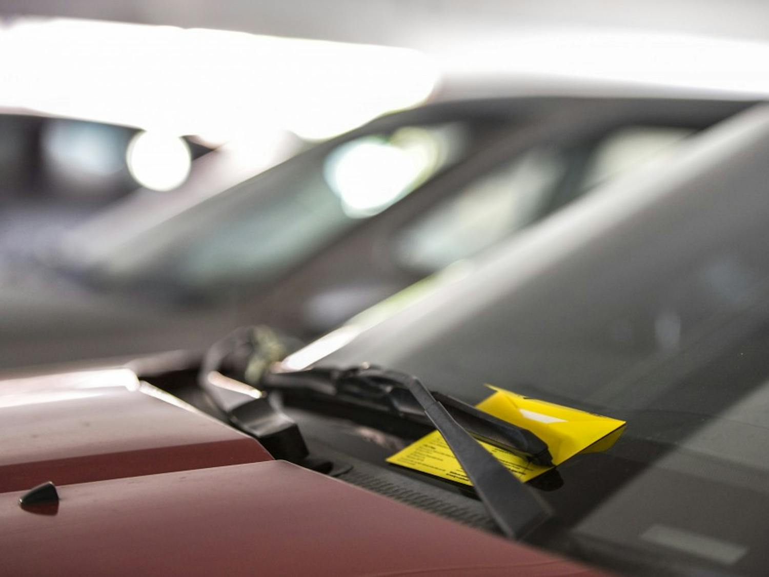 A parking citation sits placed on a vehicle at the yale structure on UNM Main Campus Wednesday Sept. 21, 2016. The UNM Bursar's office and the Parking and Transportation office can threaten to disenroll students that have outstanding parking violations, even if family member are at fault. 