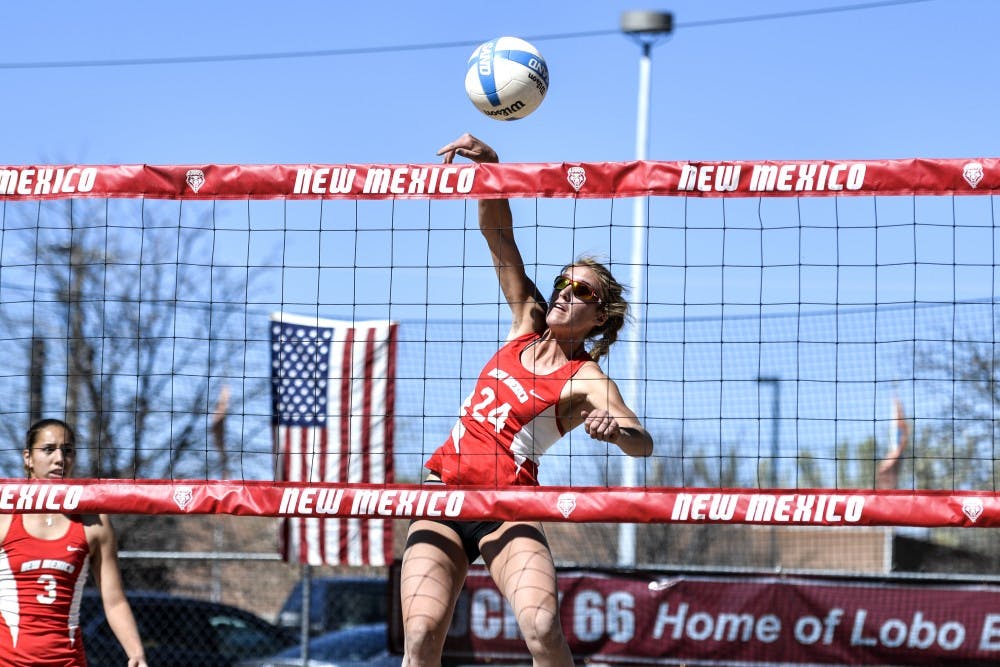 Junior Cassie House jumps up to spike the ball at Lucky 66 Bowl’s sand volleyball courts. The Lobos will play this weekend in California with their first game against Pacific this Friday. 