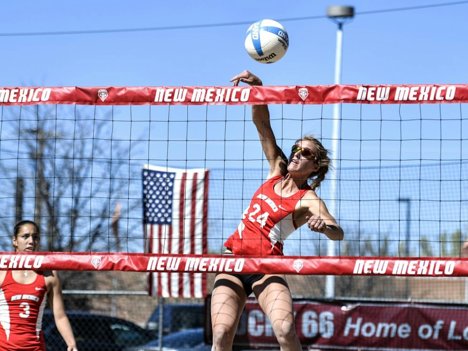 Junior Cassie House jumps up to spike the ball at Lucky 66 Bowl’s sand volleyball courts. The Lobos will play this weekend in California with their first game against Pacific this Friday. 