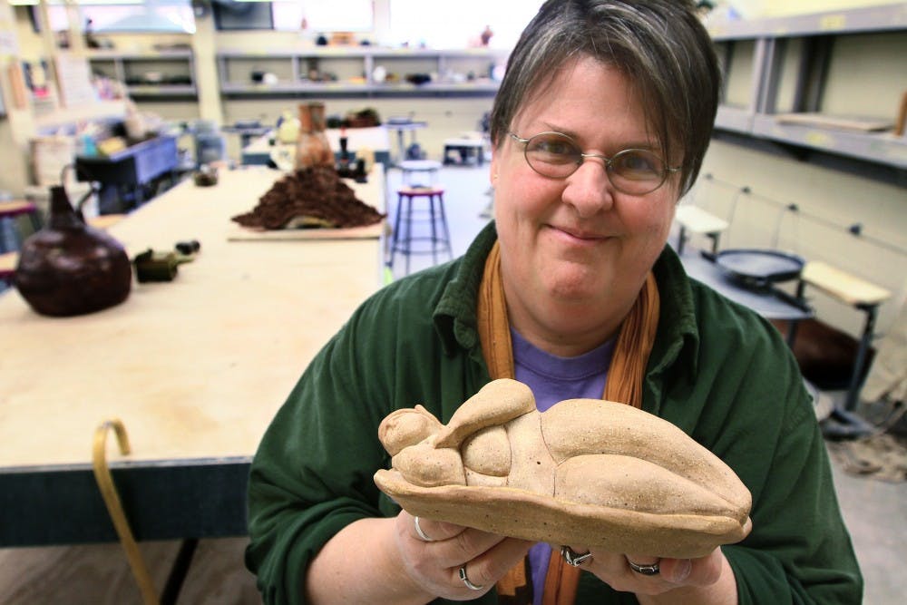 	Raven White offers one of her projects on Monday in the Art Building. She did this piece as an assignment for her ceramics class but said she probably won’t continue with ceramics, because her main focus is on photography and drawing. 