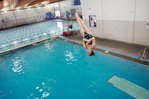 Freshman Gabby Erickson dismounts off the high board on Jan. 17 at the Sandia High School pool. Erickson finished in seventh place in the three-meter dive.
