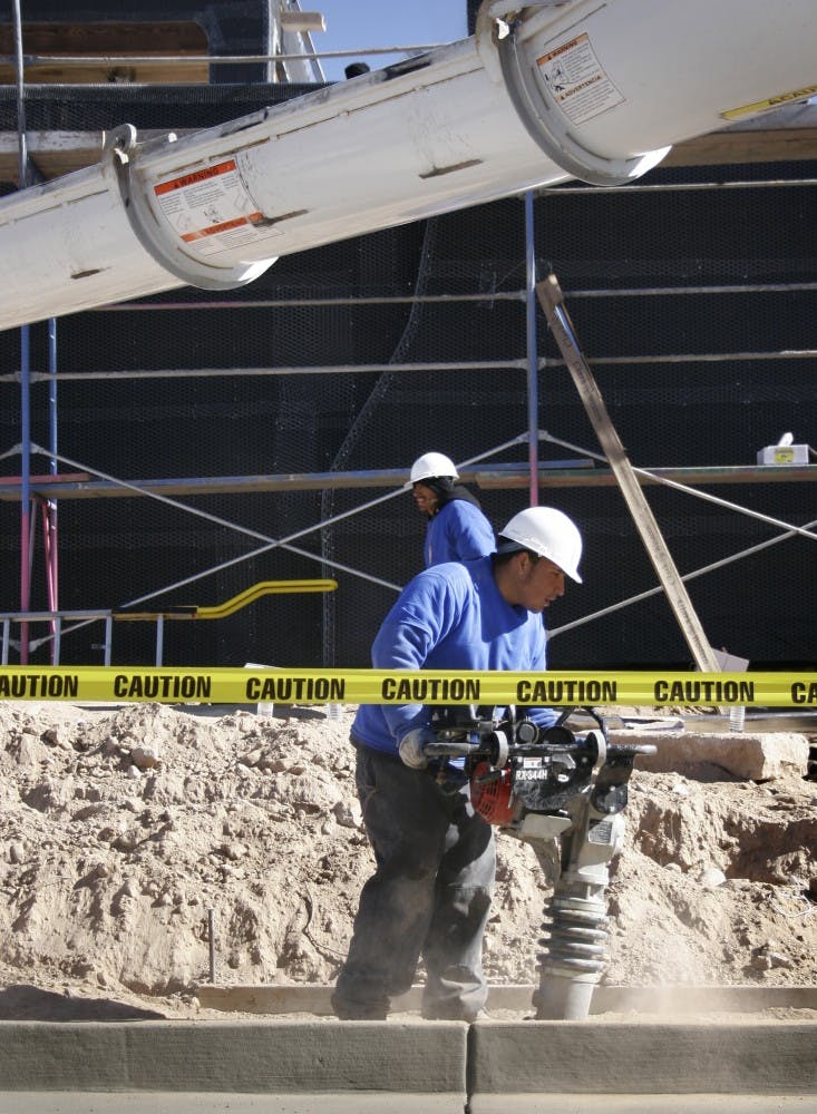 A construction worker compacts the ground as concrete is poured at the future home of the Martinez family. Being built by hundreds of workers and volunteers, the home will be featured on the show "Extreme Makeover: Home Edition."