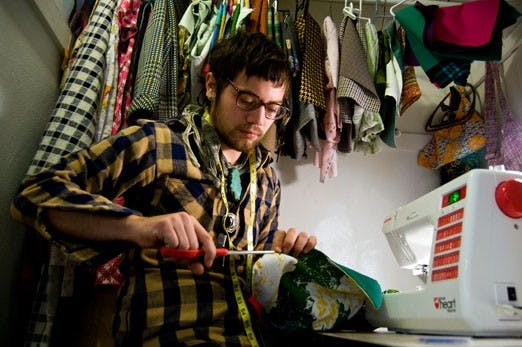 Fernando Webb cuts material in his closet. 