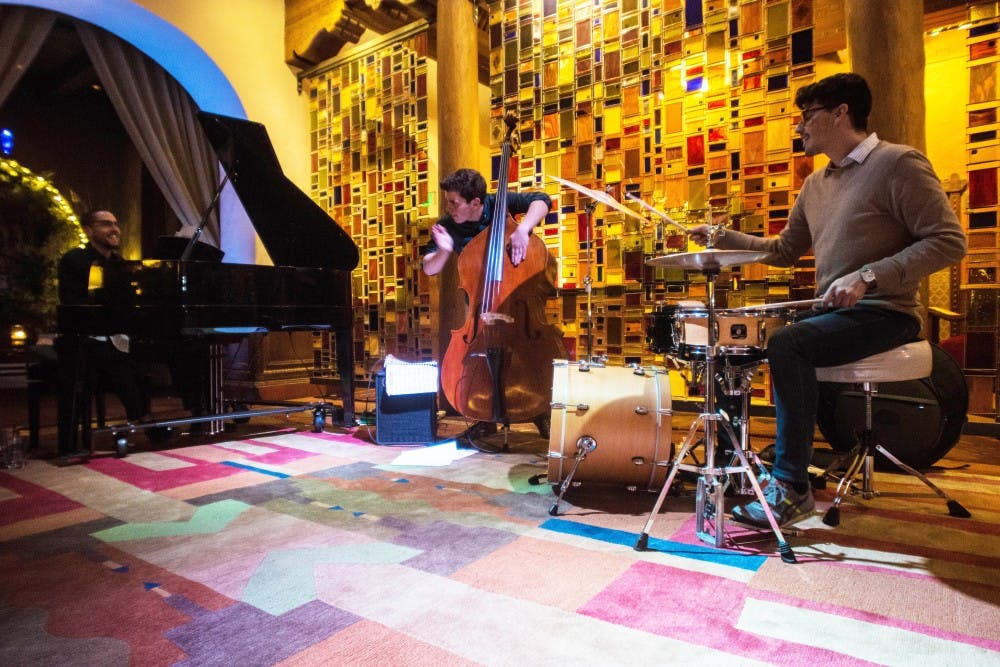 A UNM jazz ensemble comprised of current and alumni music department students, pianist, Sean Umstead, bassist, Matthew Jaeger, and percussionist, Jonathan Rodriguez, perform in the lobby of Hotel Andaluz, Wednesday Night, February 1st. 2017, in Albuquerque, NM. UNM’s department of music often showcase student formed Jazz ensembles at the hotel located off of 2nd Street and Copper Avenue.