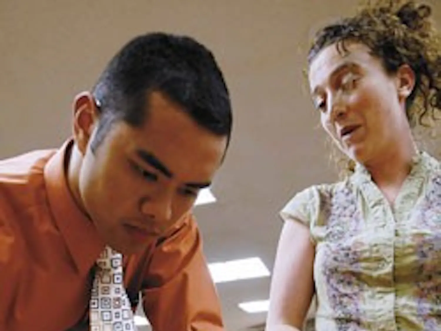 Dean Manglona signs law school student Kristin Casper's clean-energy petition to help make the University an environmentally friendly campus Monday at the UNM School of Law.