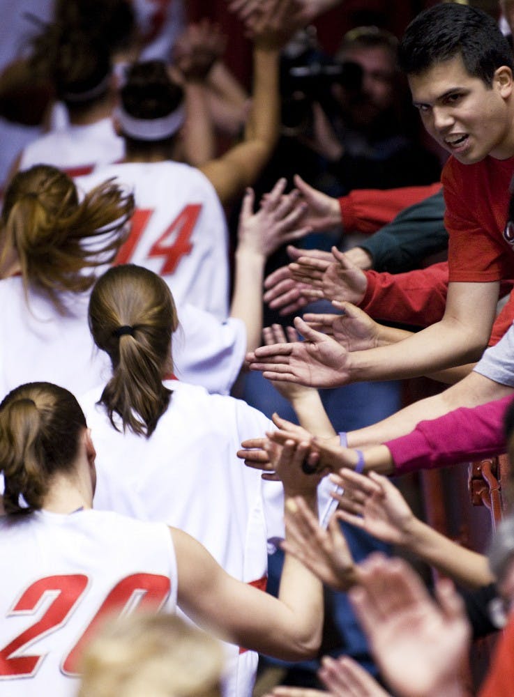 	Members of the Lobo women’s basketball team scurry up The Pit ramp while slapping fans’ hands at the conclusion of Saturday’s 60-53 win over No. 20 TCU.