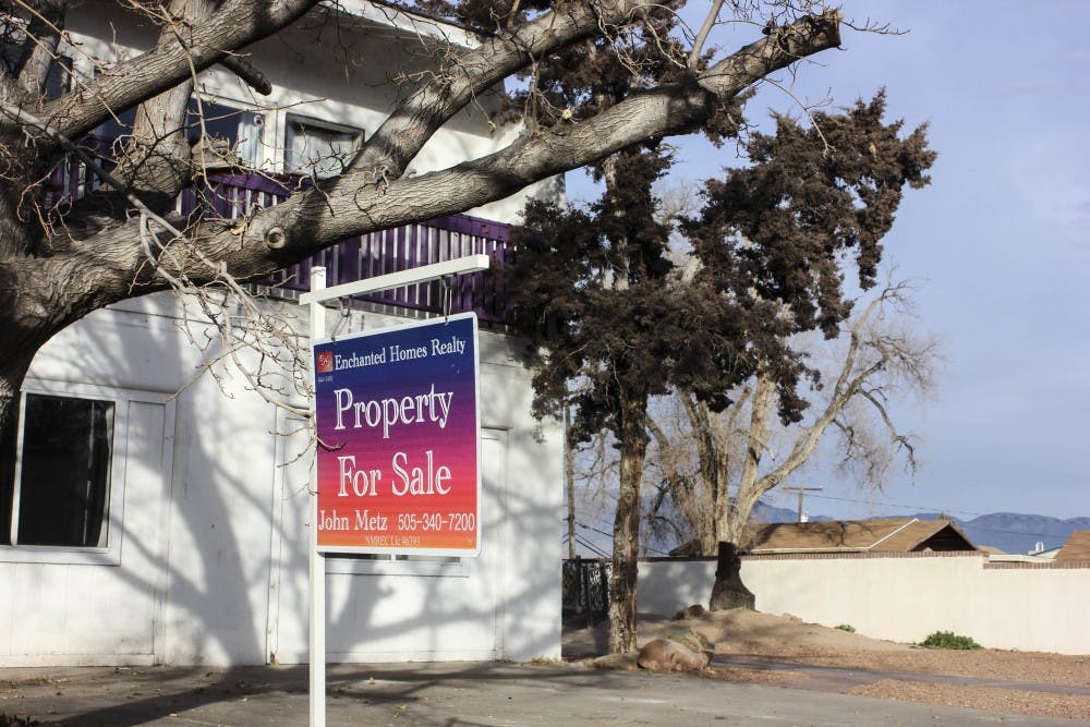 On the evening of Jan. 5, 2018, a for-sale sign hangs outside one of the recently closed FIJI houses.  
