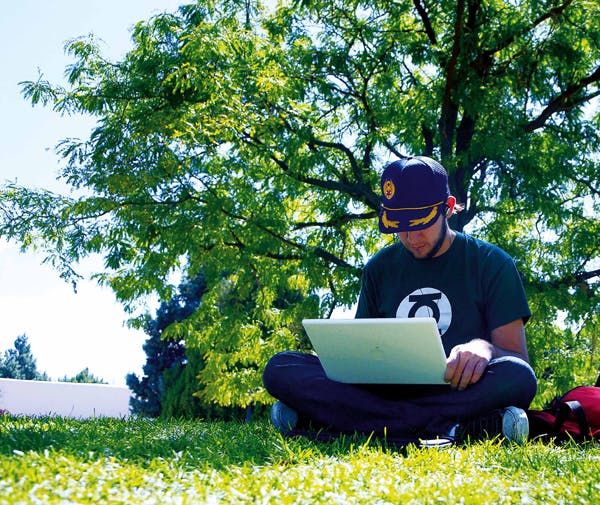 Student Kyle Johnson browses the Internet on his laptop Tuesday at the Duck Pond. Wireless networks have been installed at Smith Plaza and the Duck Pond.