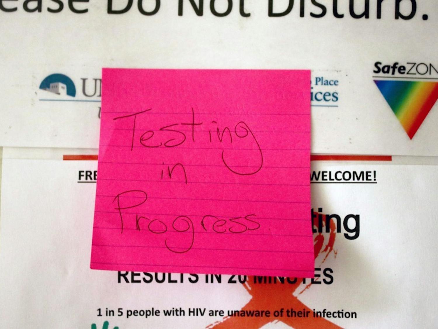 A note is posted on a door at the LGBTQ Resource Center indicated that a Sexually Transmitted Disease test is taking place.
